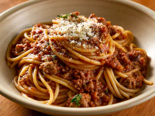 Spaghetti bolognese topped with grated parmesan